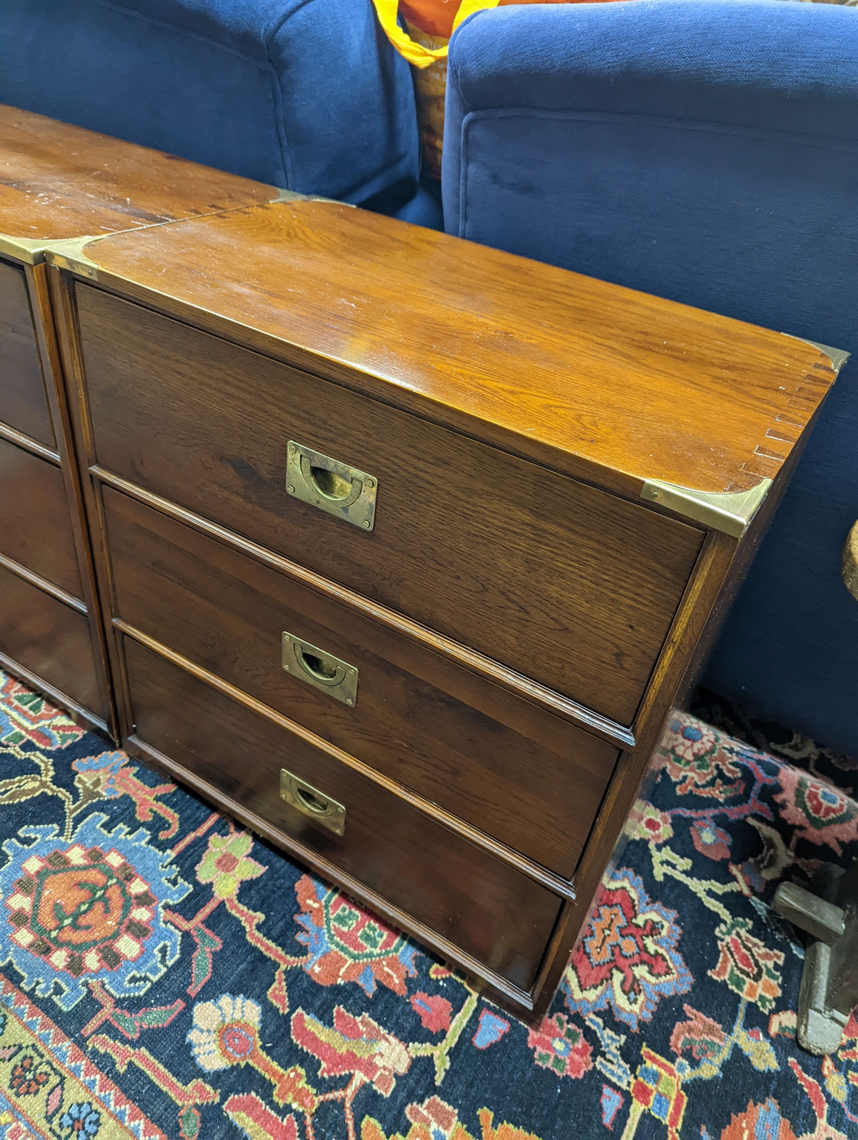 A pair of reproduction oak brass mounted military style bedside chests, width 58cm, depth 35cm, height 61cm